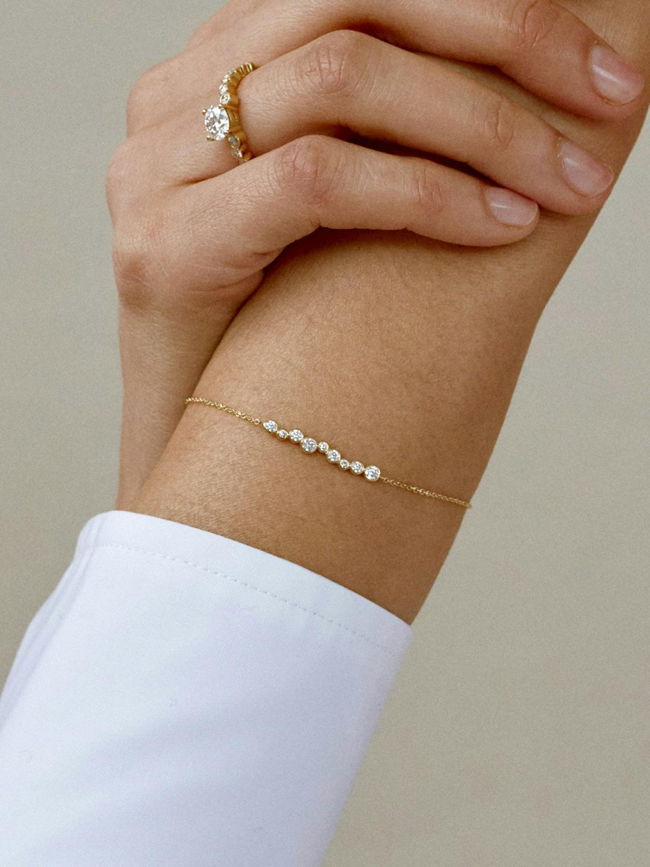 The chain cord made from 18k recycled solid gold, meets 9 circular diamond drops, also encased in 18k recycled solid gold.
