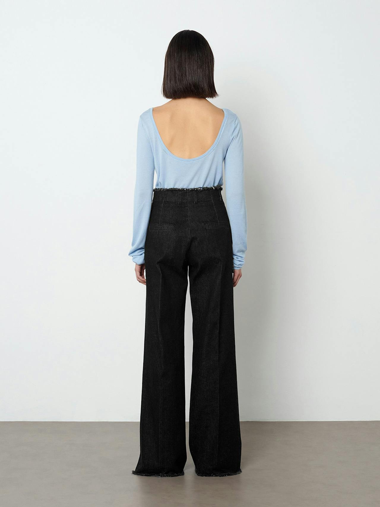The Ruth jean sits high on the waist, finished in ink black denim with a frayed edge detail at the waist and hem.