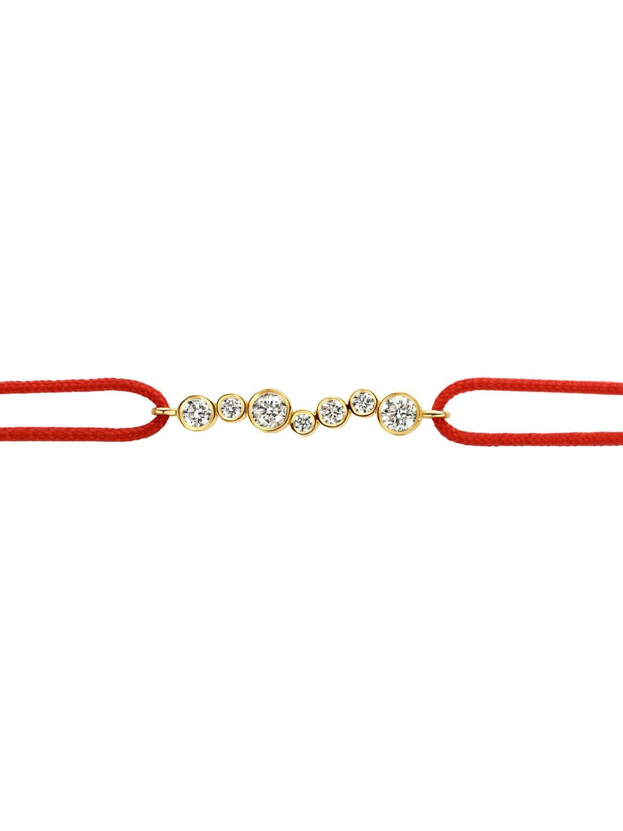The looped cord bracelet featuring a sliding knot tie, meets circular diamond drops, encased in 18k recycled solid gold.