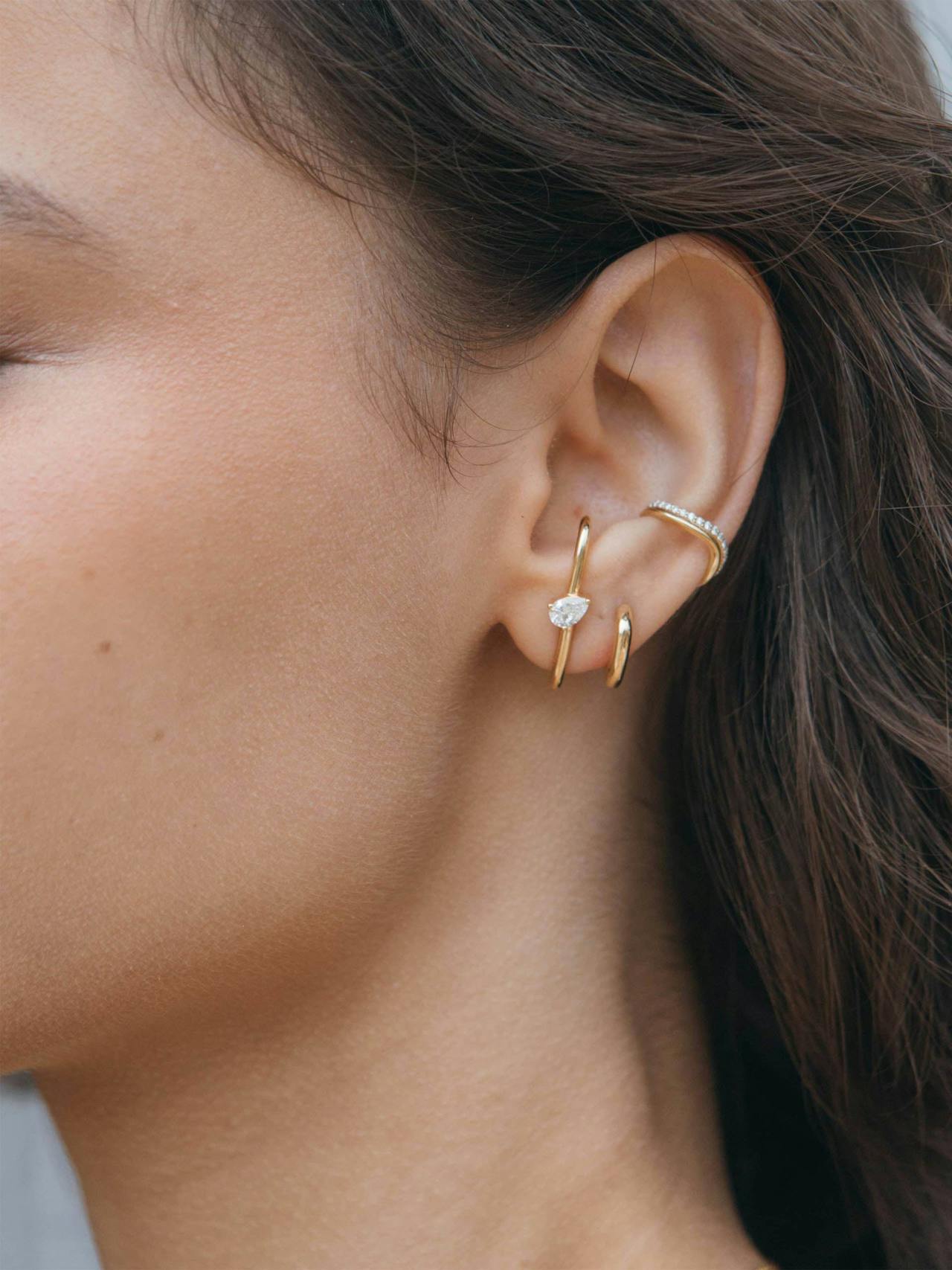 No need for piercings with our statement Double ear cuff. Inspired by the organic forms of nature, this is crafted from recycled 18k gold in an undulating shape.