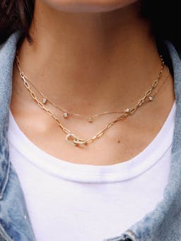 A succession of 18k polished gold chains are connected together to meet two bold brushed gold links in the middle, holding 42 brilliant lab-created diamonds with a total of 0.63ct.