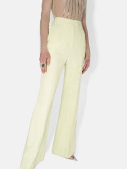 Galvan tailored pale yellow suit trousers from Resort '23 collection. Flared leg trousers. Collagerie.com